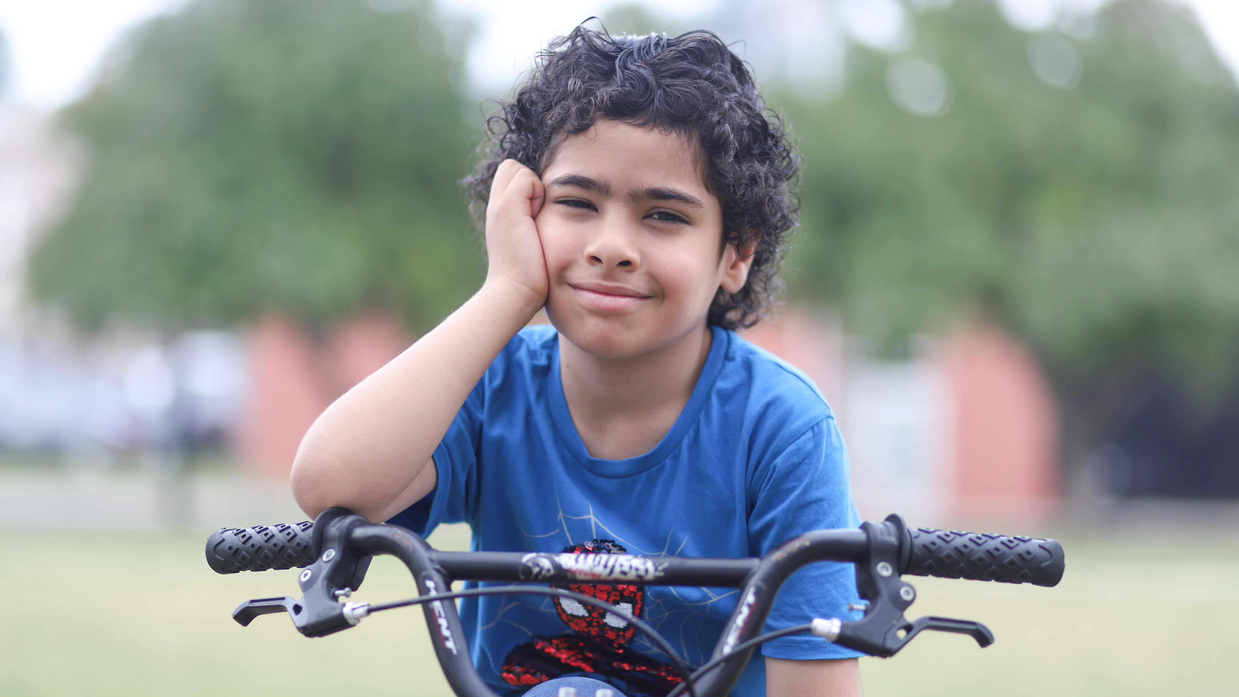 Student smiling while resting on a bike